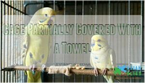 cage partially covered with a towel